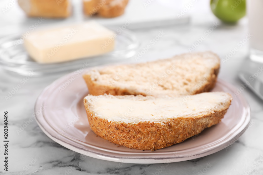 Fresh bread with tasty butter on plate Fresh bread with tasty butter on plate