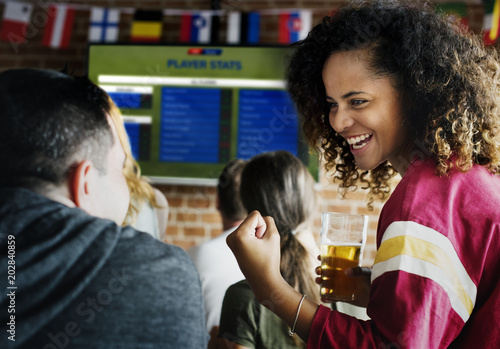 Frieds cheering sport at bar together
