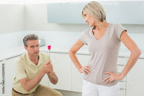 Man making a proposal to woman in kitchen