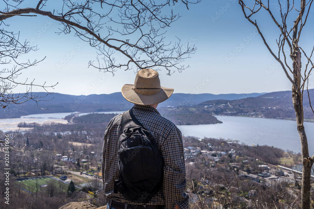 Man overlook Hudson Valley from Bull Hill hiking trail near Cold Spring, NY