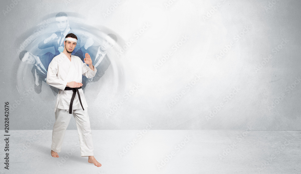 Young businessman in suit fighting with empty wall background
Young businessman in suit fighting with empty wall background