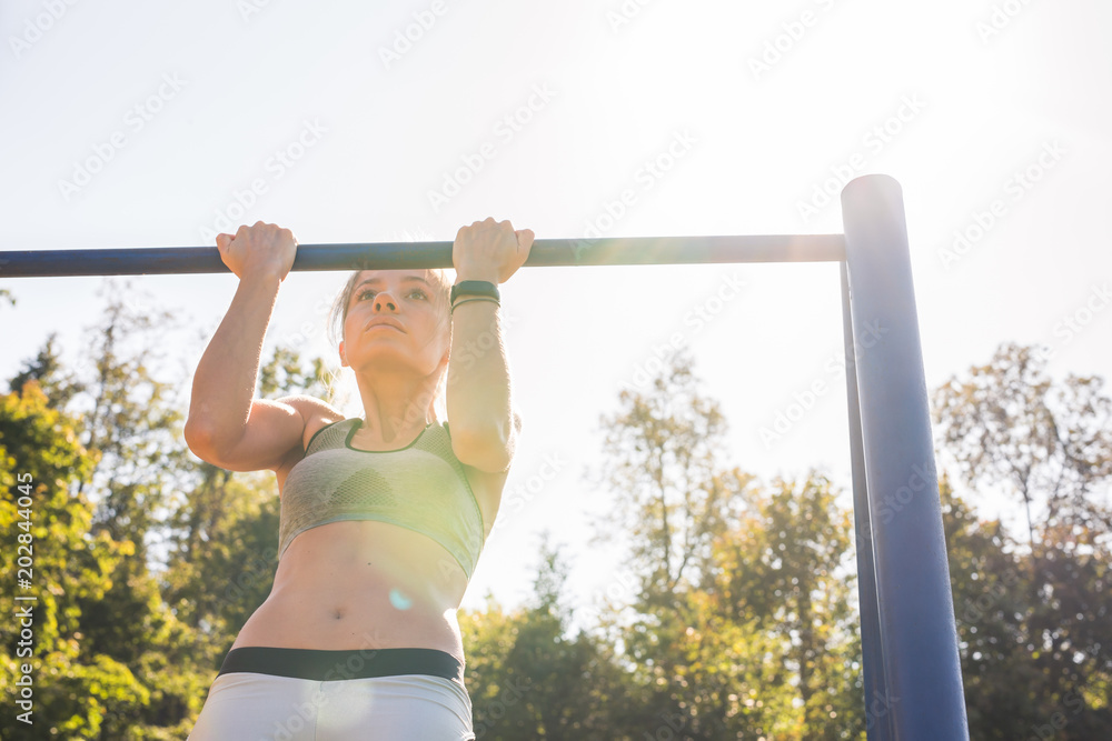 Fit woman doing pull-ups