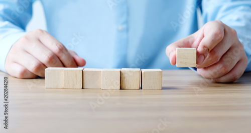 Hand holding blank wooden cubes, business concept background, mock up, template