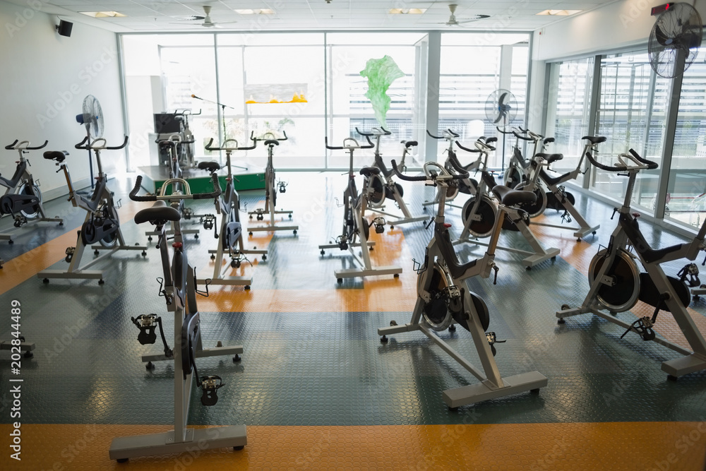 Fototapeta premium Large empty fitness studio with spin bikes