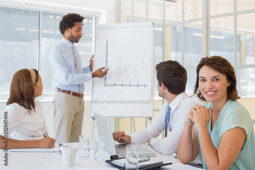 Businesswoman with colleagues in boardroom meeting