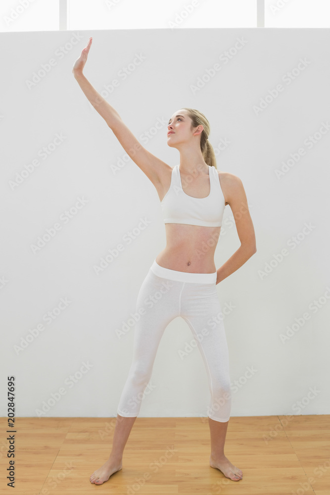 Lovely toned woman doing yoga pose for stretching her body