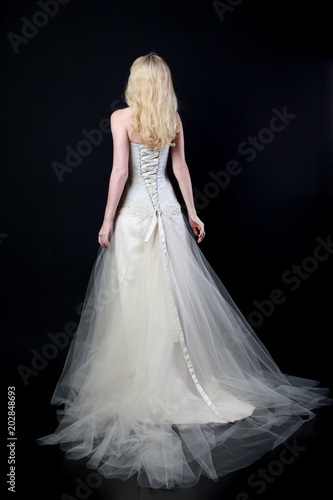 Fotografi full length portrait of woman wearing white bridal gown