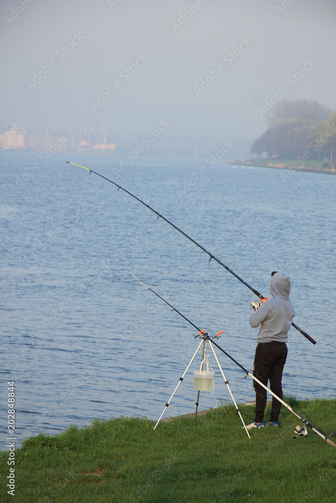 Men fishing near canal