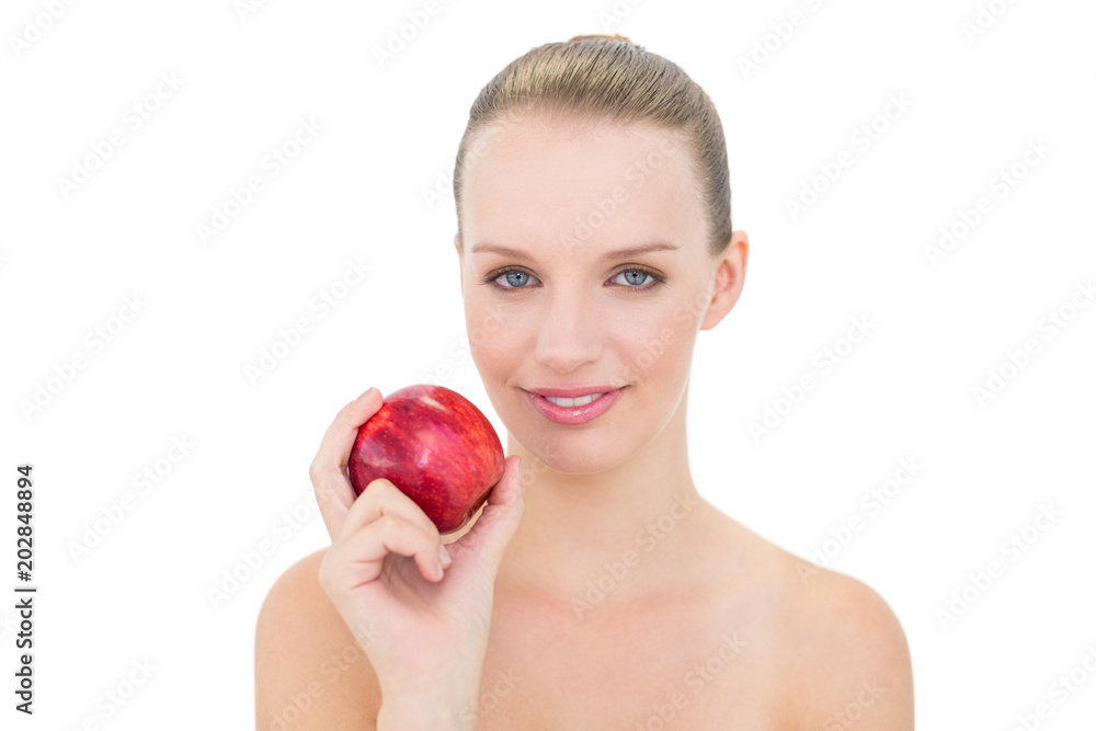 Amused pretty blonde model holding an apple Amused pretty blonde model holding an apple