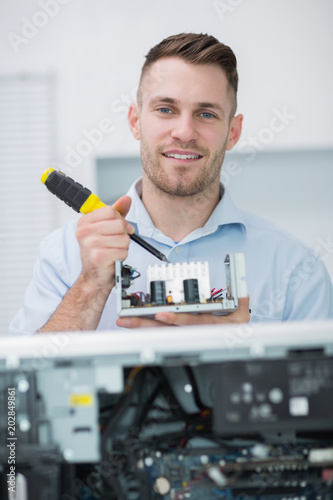 Computer engineer working on cpu part in front of open cpu