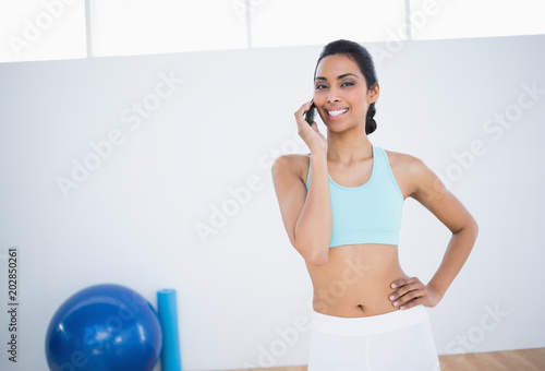 Cheerful slender woman phoning with smartphone 