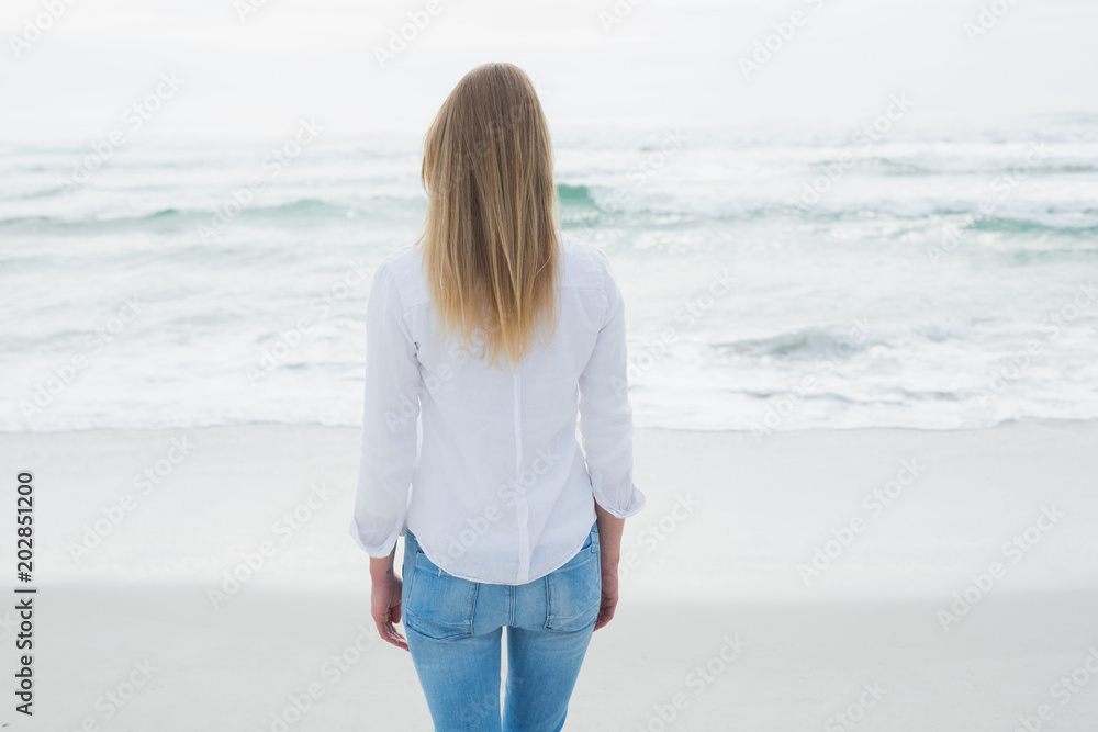 Rear view of a casual blond at beach Rear view of a casual blond at beach