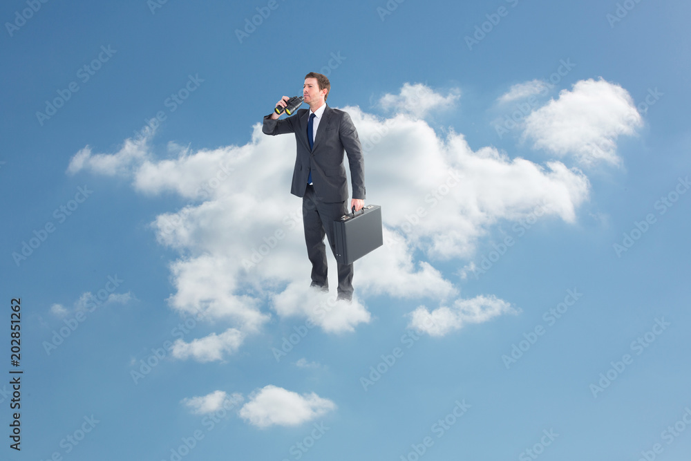 Businessman looking through binoculars against cloudy sky Businessman looking through binoculars against cloudy sky