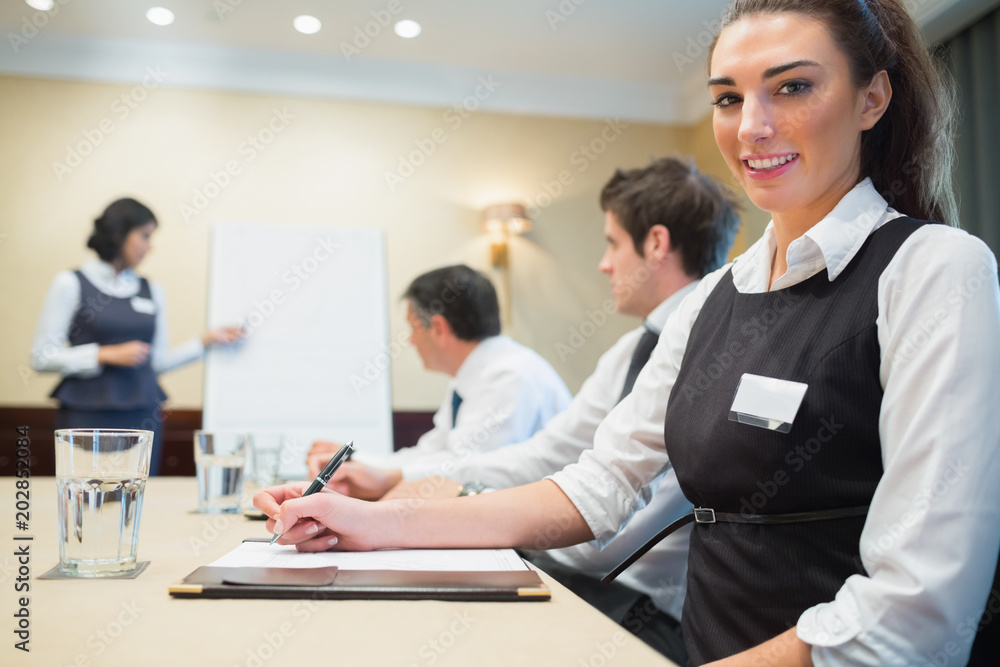 Smiling businesswoman during a presentation Smiling businesswoman during a presentation