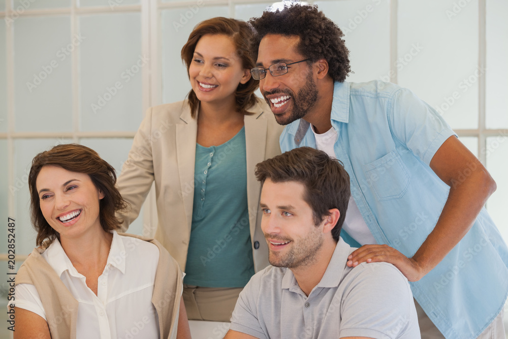 Smiling business people looking away at office Smiling business people looking away at office
