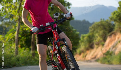 Young woman cycling mountain bike on trail