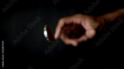 slowmotion shot tossing coin to flip on heads or tails photo