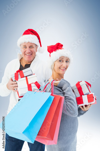 Couple with shopping bags and gifts against blue vignette