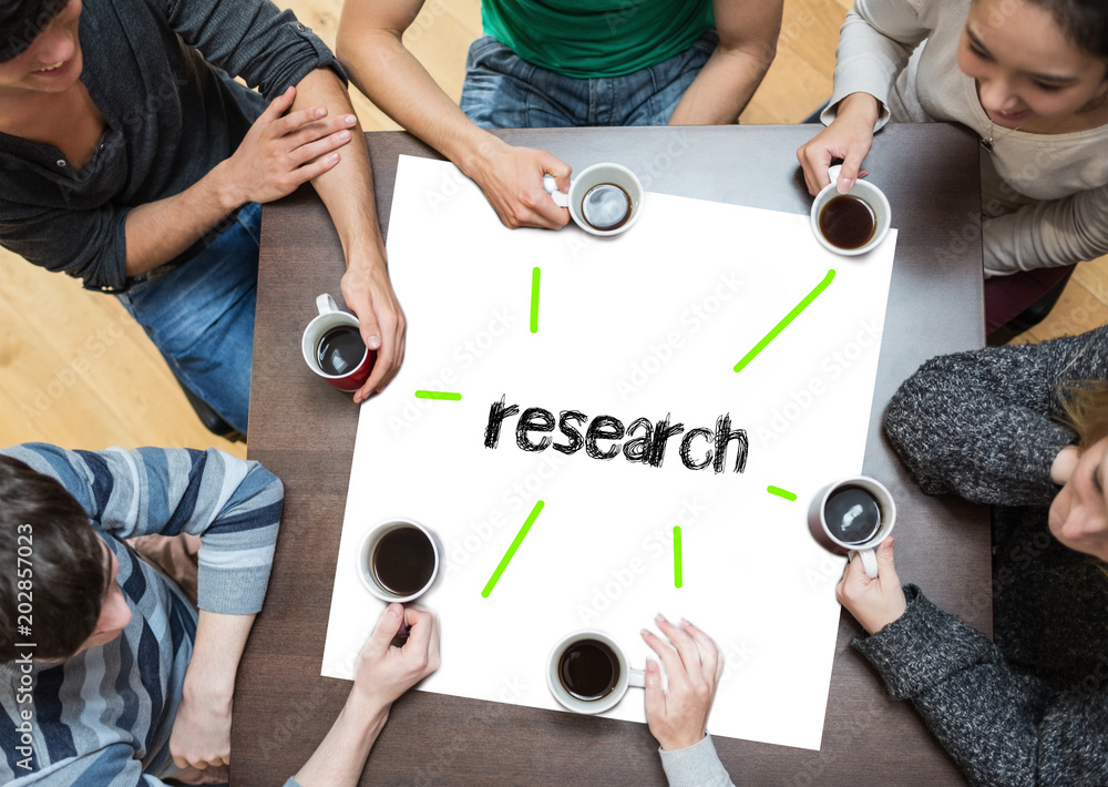 The word research on page with people sitting around table drinking coffee