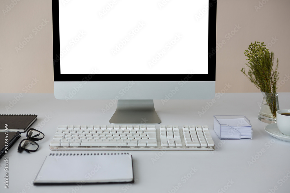 Desktop pc with coffee and diary on table Desktop pc with coffee and diary on table