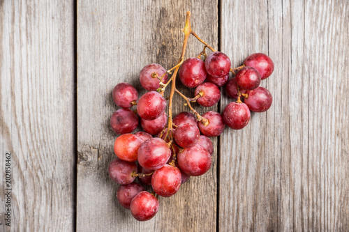 Sweet bunch of red grapes on th rustic background. Selective focus. Shallow depth of field.