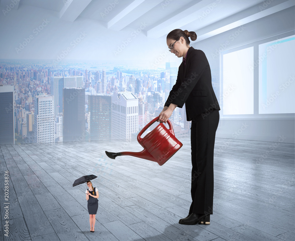 Φωτογραφία Businesswoman watering tiny businesswoman against city scene in a room
