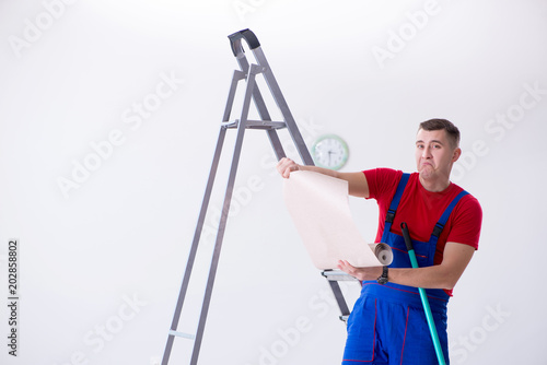 Contractor worker preparing for wallpaper decoration