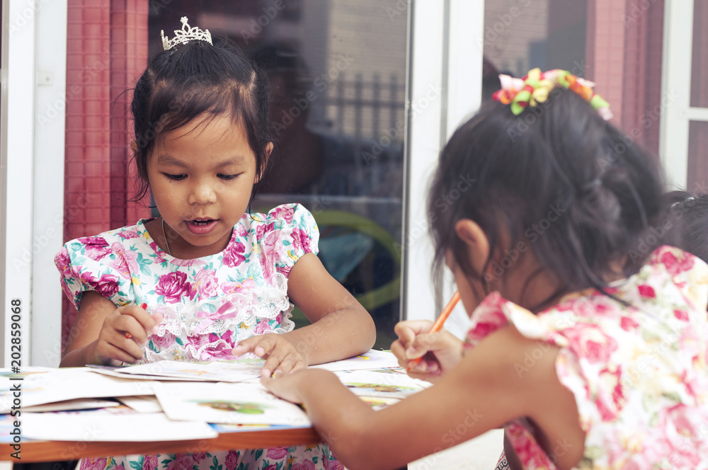 Happy Children Enjoy Writing Alphabet and Drawing Picture with Color Pencil in Homework at Lovely Family House Happy Children Enjoy Writing Alphabet and Drawing Picture with Color Pencil in Homework at Lovely Family House