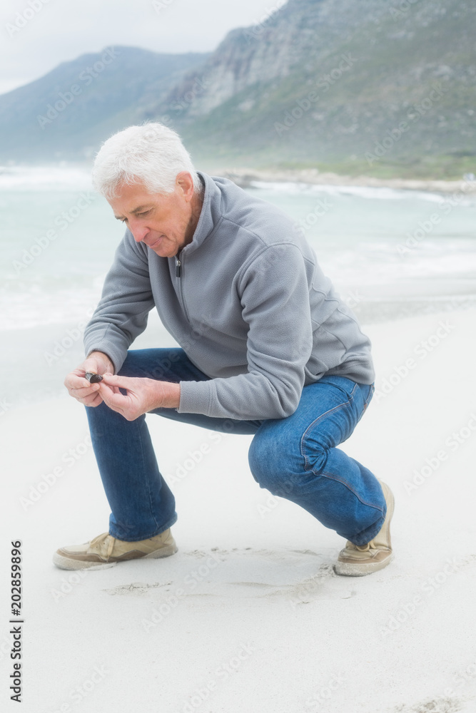 Side view of a senior man relaxing at beach