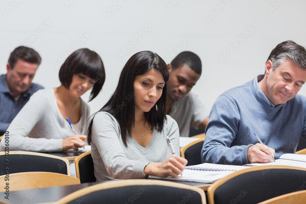 Students taking notes in lecture Students taking notes in lecture