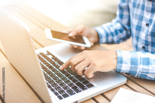 Asian young businessman working on his laptop. Digital Economy.