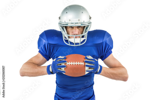 Portrait of confident sports player holding ball