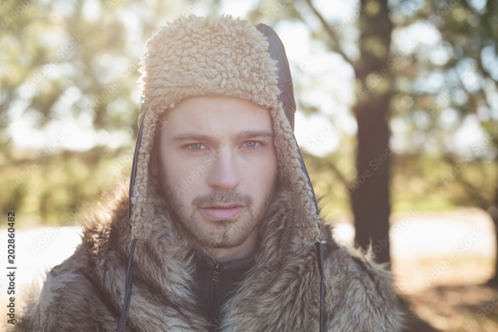 Close up of a handsome man in warm clothing in forest Close up of a handsome man in warm clothing in forest