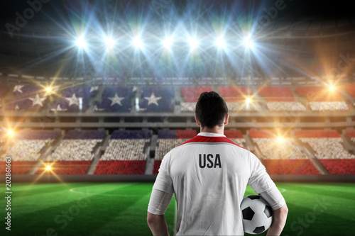 Usa football player holding ball against stadium full of usa football fans © vectorfusionart