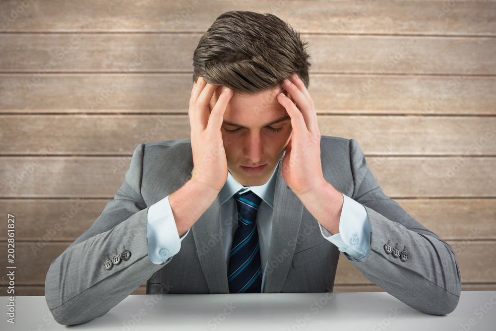 Anxious businessman against wooden surface with planks Anxious businessman against wooden surface with planks