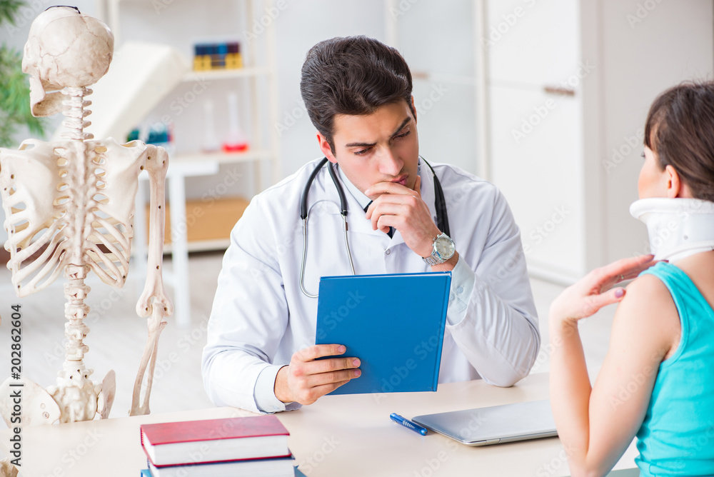 Doctor is explaining to patient with neck injury Doctor is explaining to patient with neck injury