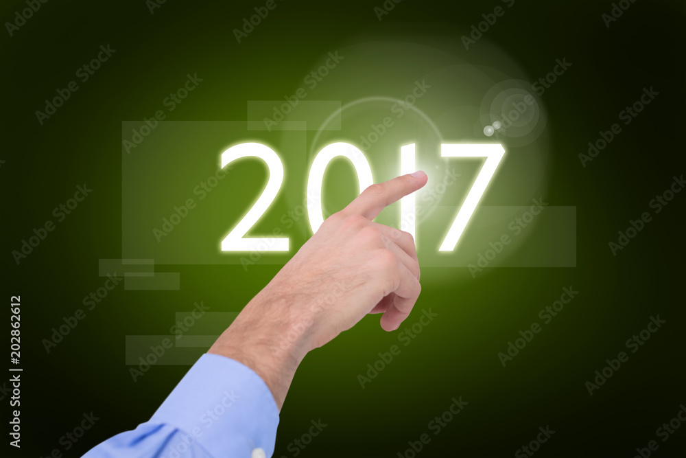 Hand of a businessman pointing something against green background with vignette Hand of a businessman pointing something against green background with vignette