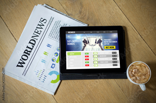 Sport app against digital tablet with coffee and newspaper on table