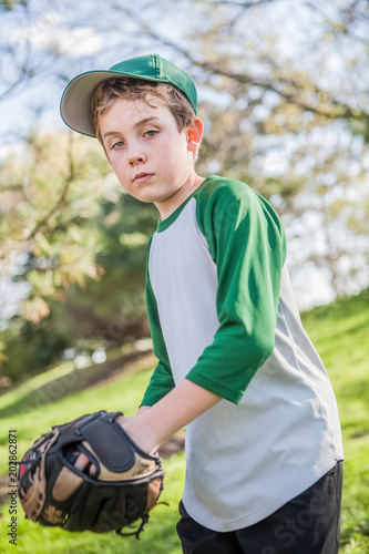 Young boy playing baseball in his backyard