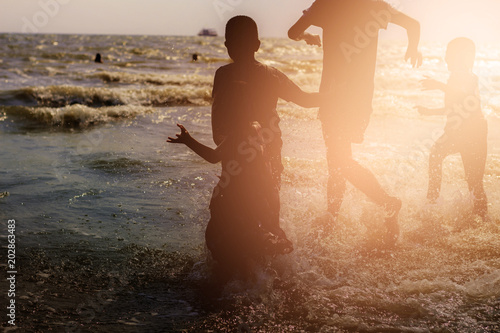 Childrend are running on beach. photo