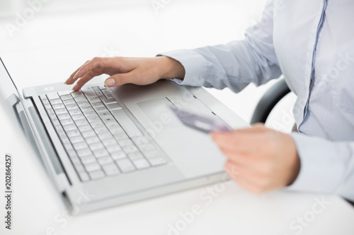 Close up mid section of a woman doing online shopping