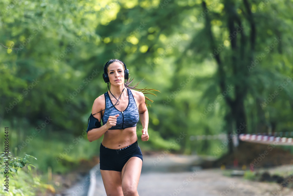 Young fitness woman jogging in the park