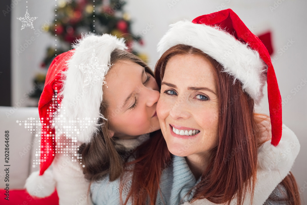 Festive mother and daughter on the couch against hanging stars Festive mother and daughter on the couch against hanging stars