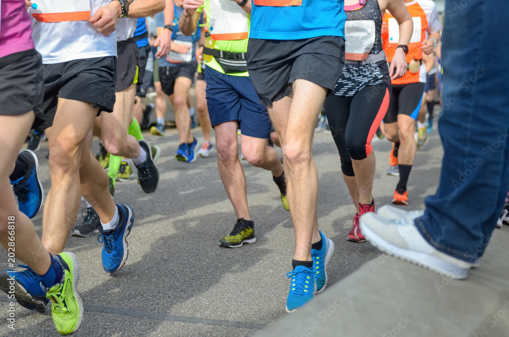 Marathon running race, many runners feet on road racing, sport competition, fitness and healthy lifestyle concept
Marathon running race, many runners feet on road racing, sport competition, fitness and healthy lifestyle concept
