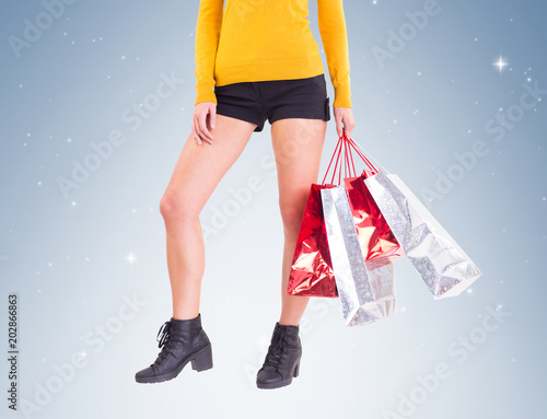 Stylish woman with shopping bags on vignette background