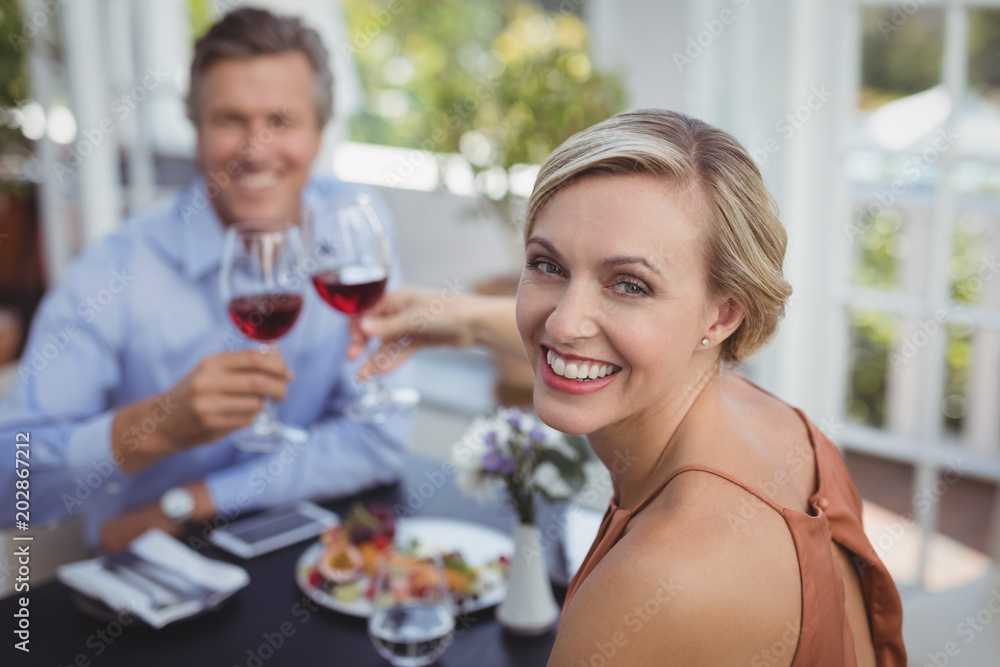 Happy couple toasting wine glass while having meal Happy couple toasting wine glass while having meal