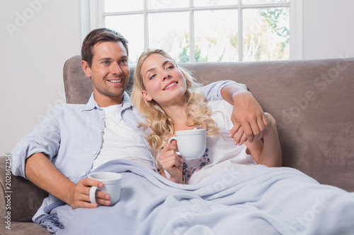 Relaxed loving couple with coffee cups in living room © WavebreakmediaMicro