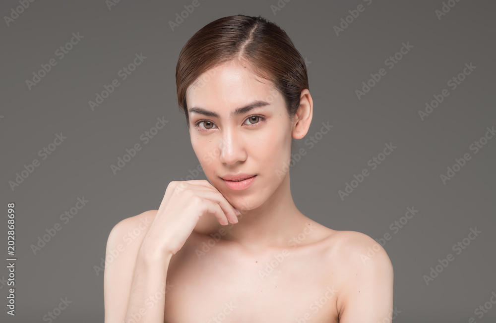 Young beautiful asia woman touching her face isolated on gray background concept skincare cosmetic Young beautiful asia woman touching her face isolated on gray background concept skincare cosmetic