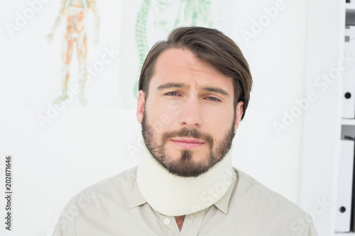 Portrait of a young man suffering from neck pain