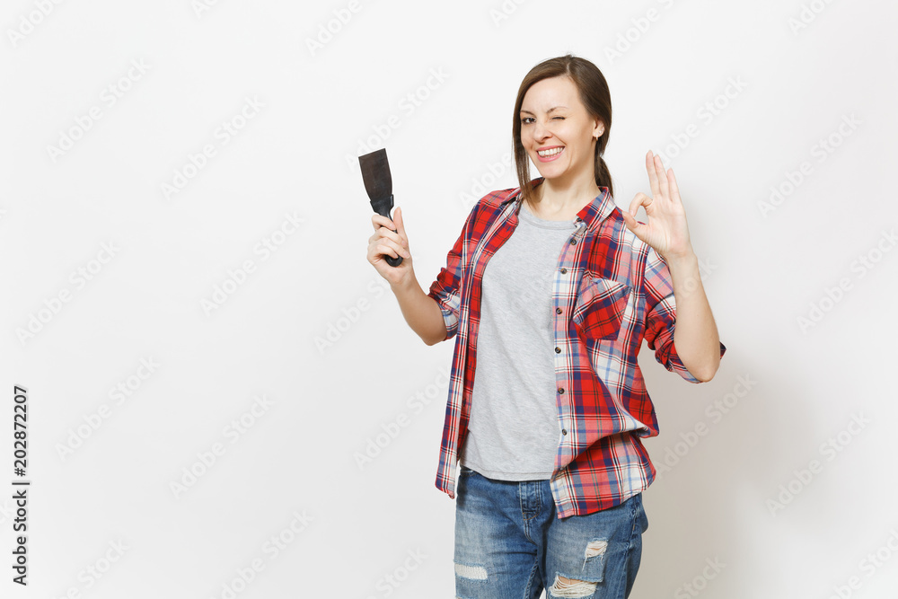 Young smiling beautiful woman in casual clothes holding putty knife and showing OK gesture isolated on white background. Instruments, accessories for renovation apartment room. Repair home concept. Young smiling beautiful woman in casual clothes holding putty knife and showing OK gesture isolated on white background. Instruments, accessories for renovation apartment room. Repair home concept.
